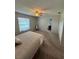 Bedroom featuring a bed, chair, carpet floors, and a view to the ensuite bathroom at 8057 Marcella Dr, Orlando, FL 32836