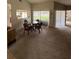 Bright dining area featuring a glass table, four wicker chairs, and sliding glass doors to the outside at 8057 Marcella Dr, Orlando, FL 32836
