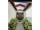 Welcoming entryway featuring a decorative door framed by greenery, providing a charming appeal at 8057 Marcella Dr, Orlando, FL 32836