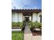 Charming entryway with a walkway lined with manicured greenery leading to the front door at 8057 Marcella Dr, Orlando, FL 32836