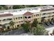 Exterior of a multistory commercial building, featuring tile roof and portico at 8057 Marcella Dr, Orlando, FL 32836