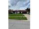 Beautiful single-story home with a red tile roof, green lawn, and a charming exterior at 8057 Marcella Dr, Orlando, FL 32836