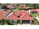 Charming single-story home featuring a red tile roof, an attached two-car garage, and lush landscaping at 8057 Marcella Dr, Orlando, FL 32836