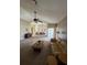 Bright living room with vaulted ceilings and a ceiling fan that opens to an adjacent dining space at 8057 Marcella Dr, Orlando, FL 32836