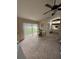 Main bedroom with a ceiling fan, neutral carpet, a desk area, and natural light at 8057 Marcella Dr, Orlando, FL 32836