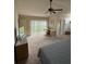 Bright main bedroom with a ceiling fan, neutral carpet, and sliding glass door at 8057 Marcella Dr, Orlando, FL 32836