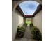 Inviting covered entryway with lush greenery lining the walkway, leading to the home at 8057 Marcella Dr, Orlando, FL 32836