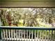 Lush trees and green field views from an exterior balcony at 806 Pinewood Ct # 3135/6, Haines City, FL 33844