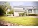 This home's exterior features stone accents, mature palm trees, and lush landscaping at 806 Pinewood Ct # 3135/6, Haines City, FL 33844