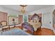 Elegant bedroom featuring stained-glass window, vintage chair, and decorative details at 822 W Patterson St, Lakeland, FL 33803