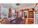 Elegant dining room with red walls, chandelier, hardwood floors, and period furnishings at 822 W Patterson St, Lakeland, FL 33803