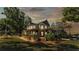 Exterior shot of home with wraparound porch, set against a scenic sky at dusk at 822 W Patterson St, Lakeland, FL 33803