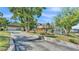 Two-story home with a covered porch, a garage, and a long concrete driveway at 822 W Patterson St, Lakeland, FL 33803