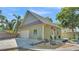 Charming home featuring a lush lawn, a detached garage, and a quaint front yard at 822 W Patterson St, Lakeland, FL 33803