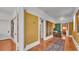 Hallway with hardwood floors and decorative rugs connecting various rooms at 822 W Patterson St, Lakeland, FL 33803