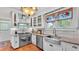 Well-lit kitchen with stainless steel appliances, granite countertops, tiled backsplash and ample cabinetry at 822 W Patterson St, Lakeland, FL 33803