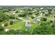 Aerial view of home nestled within lush community featuring mature trees at 911 Mendoza Ln, Kissimmee, FL 34758