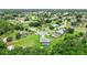Aerial view of home nestled within lush community featuring mature trees at 911 Mendoza Ln, Kissimmee, FL 34758