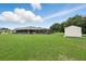 Large backyard with an enclosed patio and separate shed, and a great view of the lawn at 911 Mendoza Ln, Kissimmee, FL 34758
