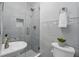 Beautiful bathroom featuring glass shower, gray tiles, and a modern sink at 911 Mendoza Ln, Kissimmee, FL 34758