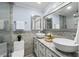 Elegant bathroom featuring double vessel sinks, a decorative mirror, and neutral accents at 911 Mendoza Ln, Kissimmee, FL 34758