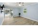 This bedroom has wood-look tile floors and a sliding door to a screened-in pool area at 911 Mendoza Ln, Kissimmee, FL 34758