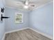Bedroom featuring wood-look tile floors, a ceiling fan, and plenty of natural light at 911 Mendoza Ln, Kissimmee, FL 34758