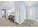 Charming entryway featuring an open-concept design, tile flooring, white cabinets and an exterior door at 911 Mendoza Ln, Kissimmee, FL 34758