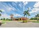 A well-maintained building complex with lush landscaping, ample parking, and a prominent clock tower feature at 911 Mendoza Ln, Kissimmee, FL 34758