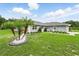 Charming single-story home with a well-manicured lawn and landscaping with a fountain at 911 Mendoza Ln, Kissimmee, FL 34758
