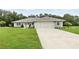 Charming single-story home featuring attached two-car garage, neutral paint, and landscaped yard at 911 Mendoza Ln, Kissimmee, FL 34758