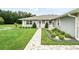 Charming single-story home with a well-manicured lawn, beautiful landscaping, and a stone walkway at 911 Mendoza Ln, Kissimmee, FL 34758