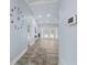 Bright hallway featuring high ceilings, modern wall decor, wood floors and an open view of the pool area at 911 Mendoza Ln, Kissimmee, FL 34758