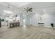 Stylish living room with vaulted ceilings, hardwood floors, and modern lighting fixtures at 911 Mendoza Ln, Kissimmee, FL 34758
