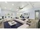 Bright living room with high ceilings, tile floors, white furniture, and an open view of the pool area at 911 Mendoza Ln, Kissimmee, FL 34758