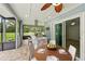 Screened in outdoor kitchen featuring stainless grill, exhaust hood, granite countertop and outdoor dining area overlooking the yard at 911 Mendoza Ln, Kissimmee, FL 34758
