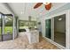 Spacious outdoor kitchen with grill, granite countertop and custom stone work, and beautiful views of yard at 911 Mendoza Ln, Kissimmee, FL 34758