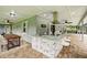 An outdoor kitchen with granite countertop and custom stone work, along with bar seating and a dining area at 911 Mendoza Ln, Kissimmee, FL 34758
