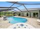 This is a beautiful screened-in pool with lots of room for seating and entertaining, plus a waterfall feature at 911 Mendoza Ln, Kissimmee, FL 34758