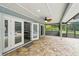 Open covered porch featuring patterned tiles with multiple entryways, and an outdoor ceiling fan at 911 Mendoza Ln, Kissimmee, FL 34758