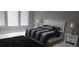 Spacious bedroom with a stylish bed, minimalist decor, and bright natural light from large windows at 9414 Haber Ct, Orlando, FL 32827