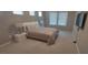 Bedroom featuring a TV, carpeted floors, and two windows at 9414 Haber Ct, Orlando, FL 32827