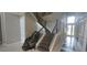 Spacious foyer showcasing dark wood stairs and a modern chandelier at 9414 Haber Ct, Orlando, FL 32827