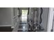 Elegant hallway featuring modern decor, stylish flooring, and a glimpse of the bright interior beyond at 9414 Haber Ct, Orlando, FL 32827