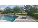 Backyard pool surrounded by lush greenery and a decorative brick patio at 9414 Haber Ct, Orlando, FL 32827