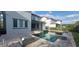 This backyard boasts a sparkling pool with modern water features, perfect for relaxation and entertaining with a sleek design at 9414 Haber Ct, Orlando, FL 32827