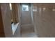 A sleek walk-in shower features marble walls and glass door, with built-in bench, for modern and luxurious experience at 9414 Haber Ct, Orlando, FL 32827