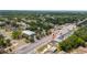 Aerial view of a residential area with tree-lined streets and a house with a red marker for location at 1009 S Ivey Ln, Orlando, FL 32811