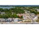 Aerial view of a residential area with tree-lined streets and a house with a red marker for location at 1009 S Ivey Ln, Orlando, FL 32811