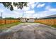 Backyard featuring a large concrete area, grassy space, and privacy fence at 1009 S Ivey Ln, Orlando, FL 32811